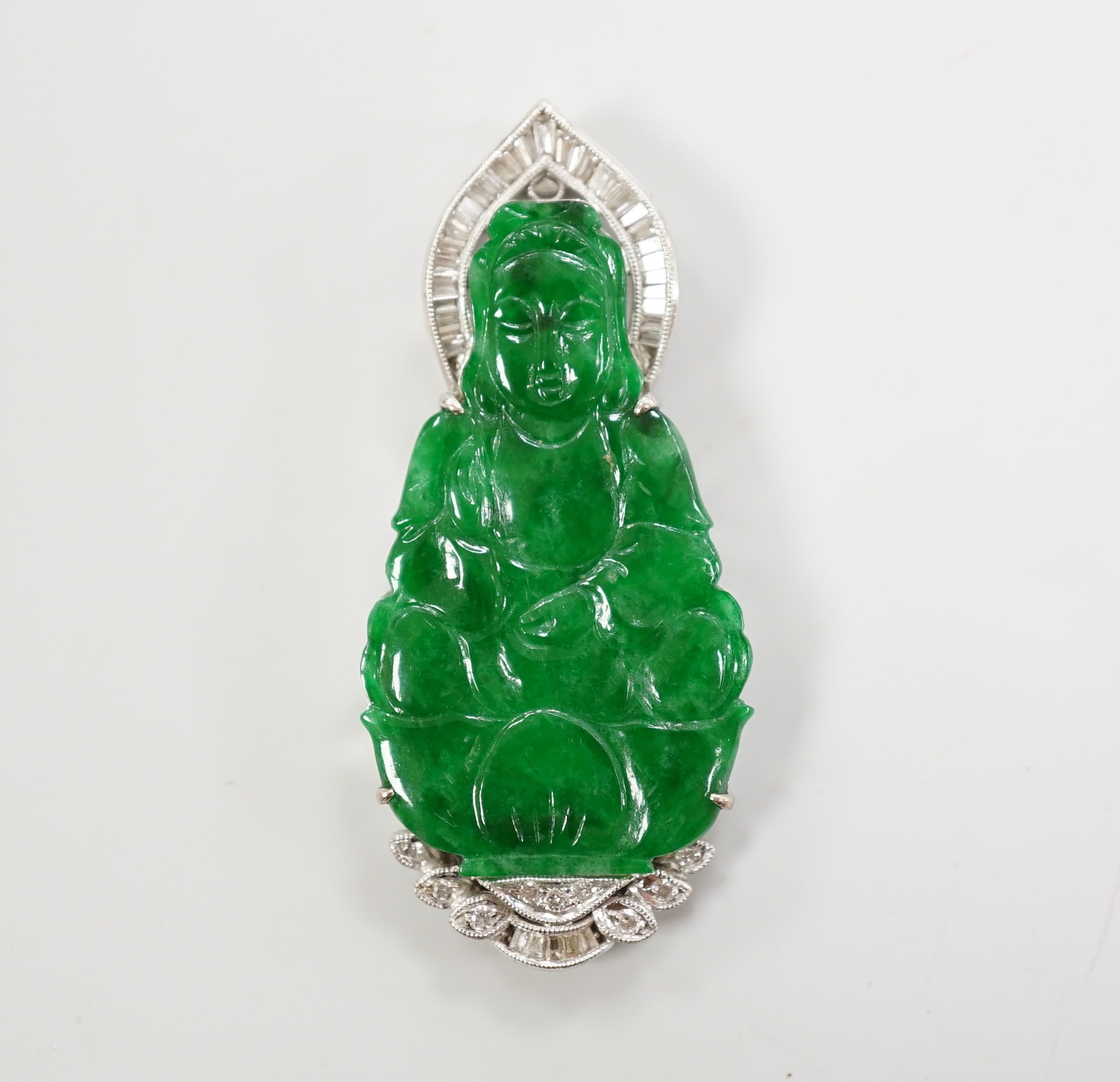 An 18k, baguette and round cut diamond cluster set carved jade figural pendant, the back with engraved hinged door, 47mm, gross weight 15.4 grams.